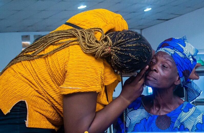 A volunteer conducting an eye check at the Ajasa outreach